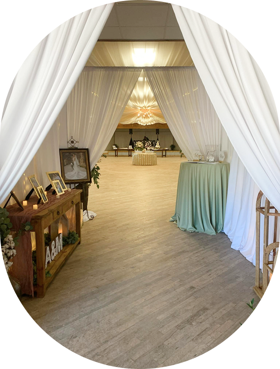 Elegant wedding reception entrance with draped curtains.