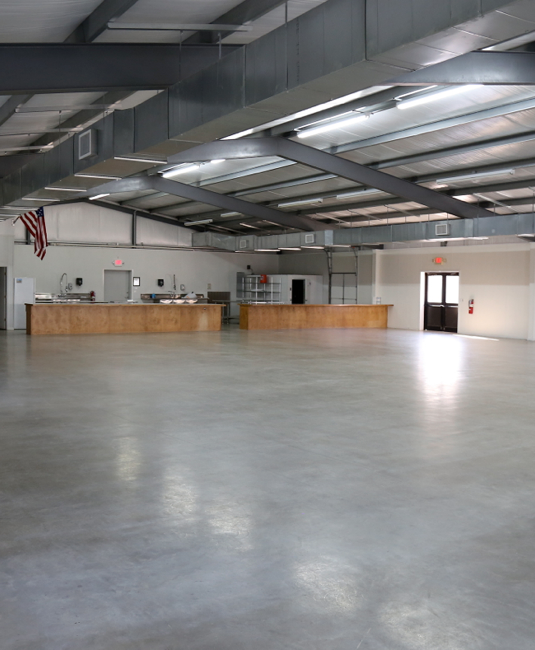 Empty industrial hall with concrete floor.