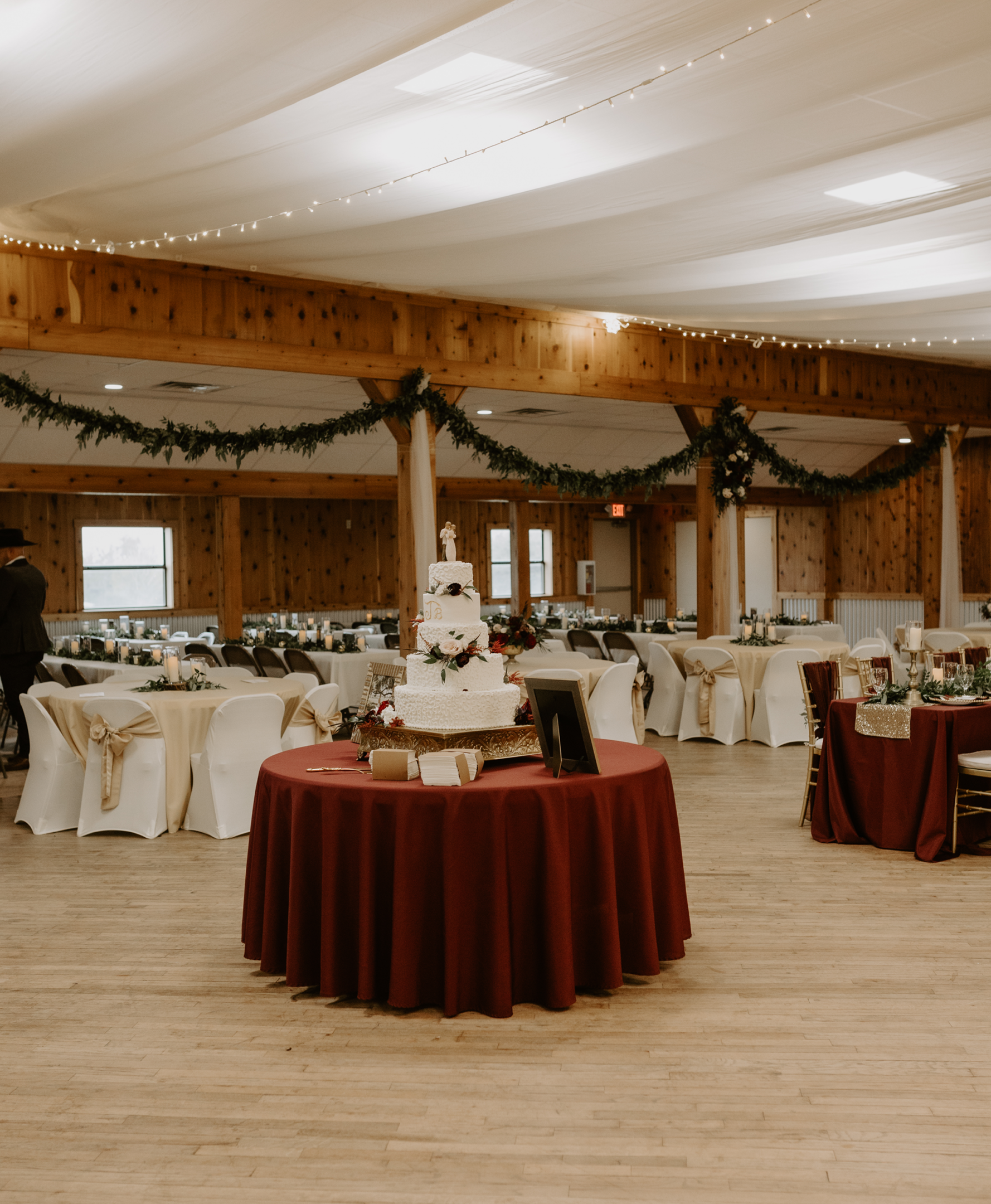 Wedding reception hall with decorated tables.